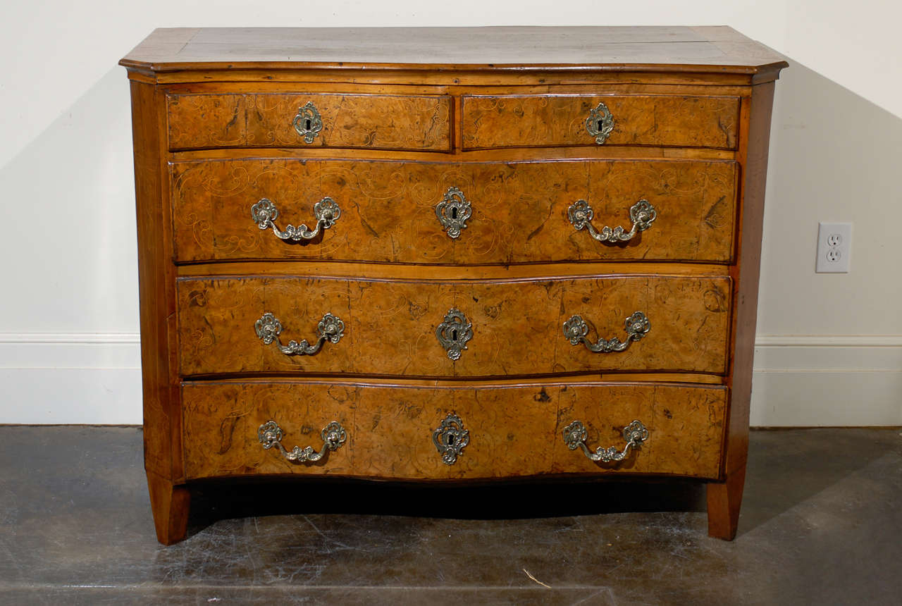 18 th c Italian walnut commode with serpentine front and inlay.