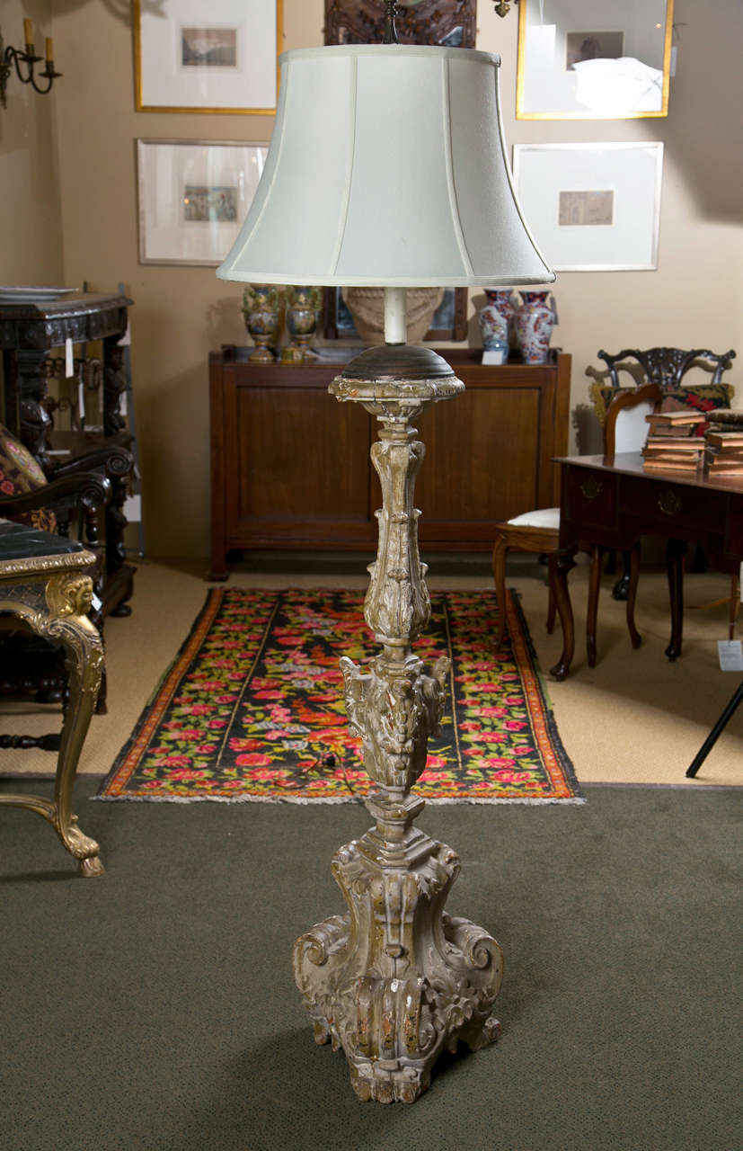 A large 18th century carved Italian prickett stick now a lamp.
Dimensions are of candlestick only.