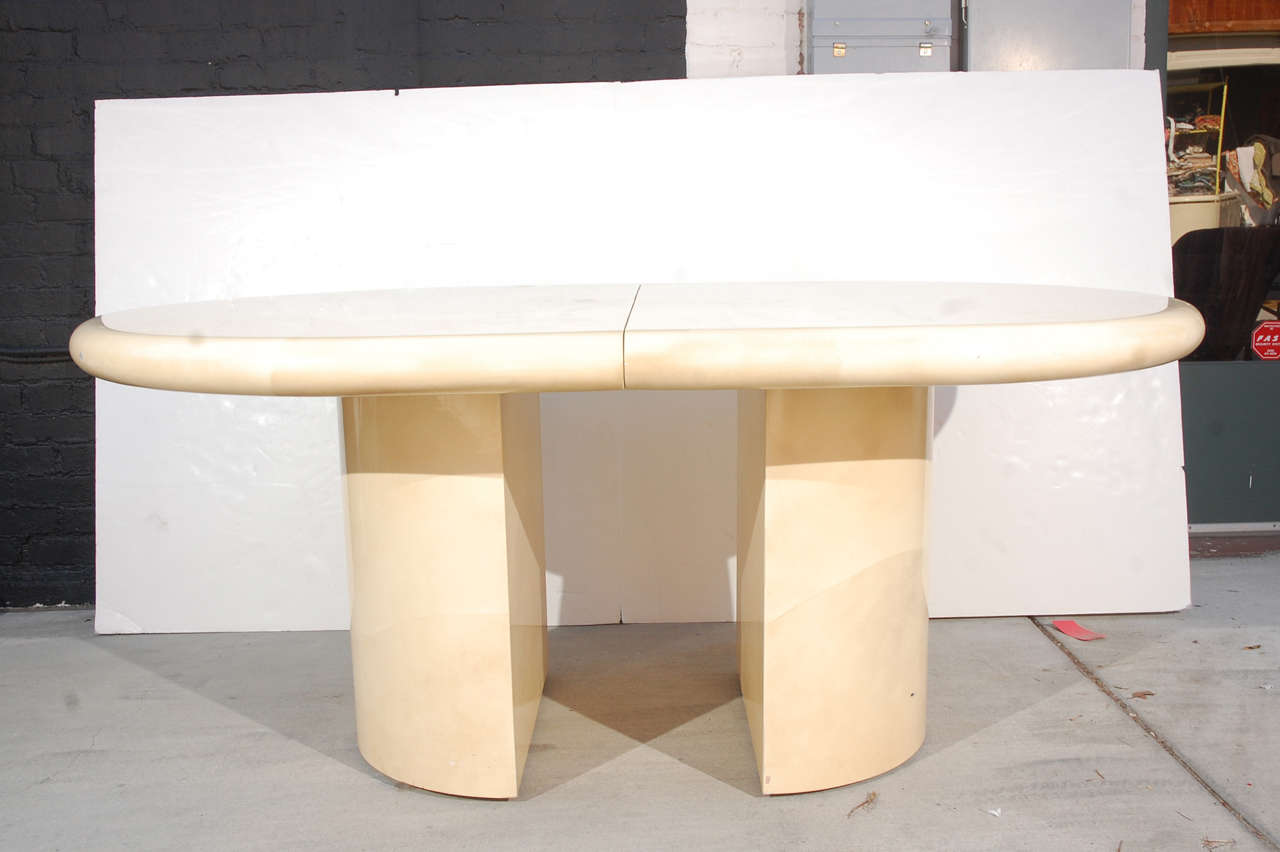 1980s Karl Springer style faux goatskin wrapped dining table on demi lune pedestals with 2 leaves