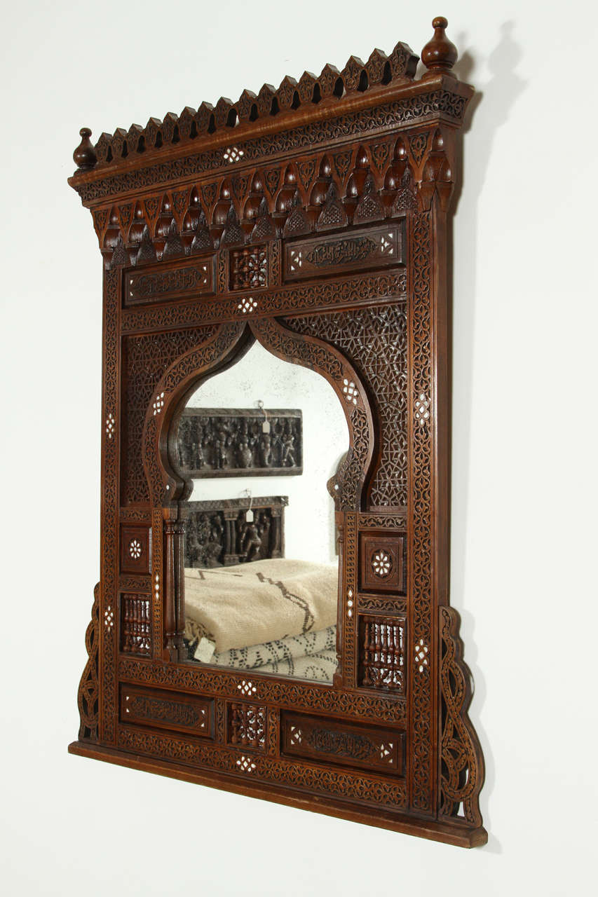 Middle Eastern Syrian Mirror Inlaid with Mother of Pearl, intricately and finely handcarved and incrusted with mother of pearl.
Caligraphy scripts all over.
Mosaik provides Antiques, Moorish Style, Spanish, African, Islamic Art, Arabian, Middle