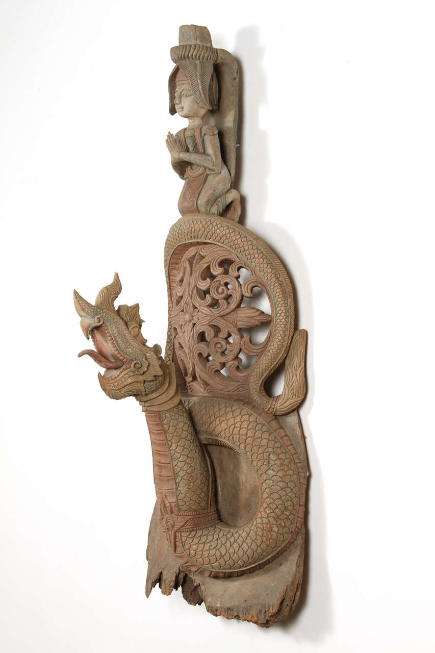 Asian Thai Buddhist sculpture of deity of fertility and dragon.
Architectural wooden sacred architectural piece turned into a Buddhist art sculpture.
Could be hang on the wall.
The Dragon in Asian culture represent life, blessing and fertility.
 