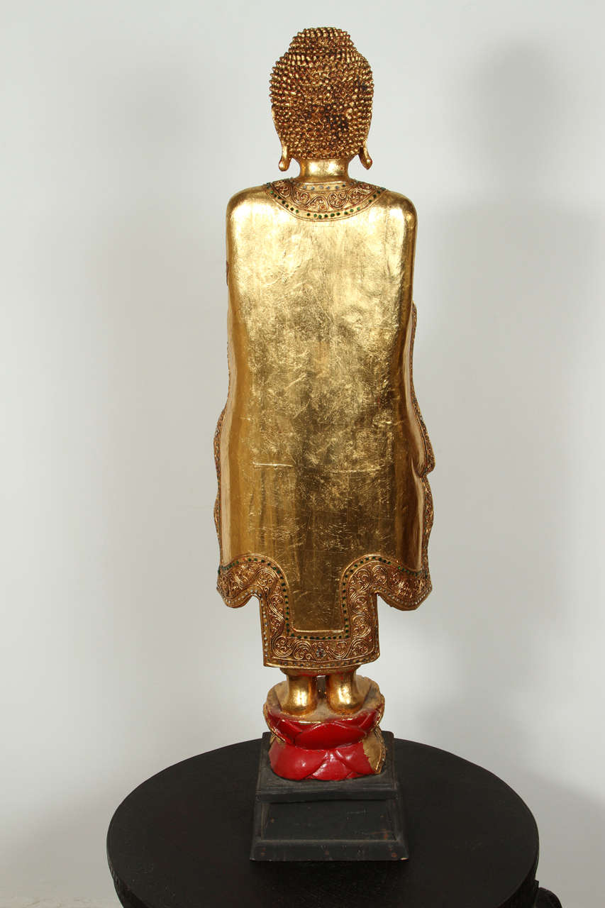 Gilded wooden figure of a Thai standing Buddha.
 