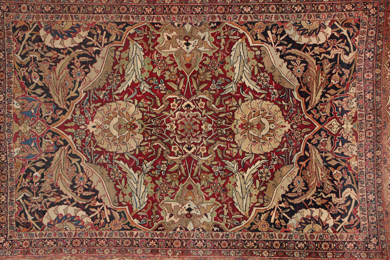 This Persian Kermanshah carpet circa 1890 consists of a handspun, hand-knotted wool pile, cotton warp and thread, and natural vegetable dyes. The size is 9'2