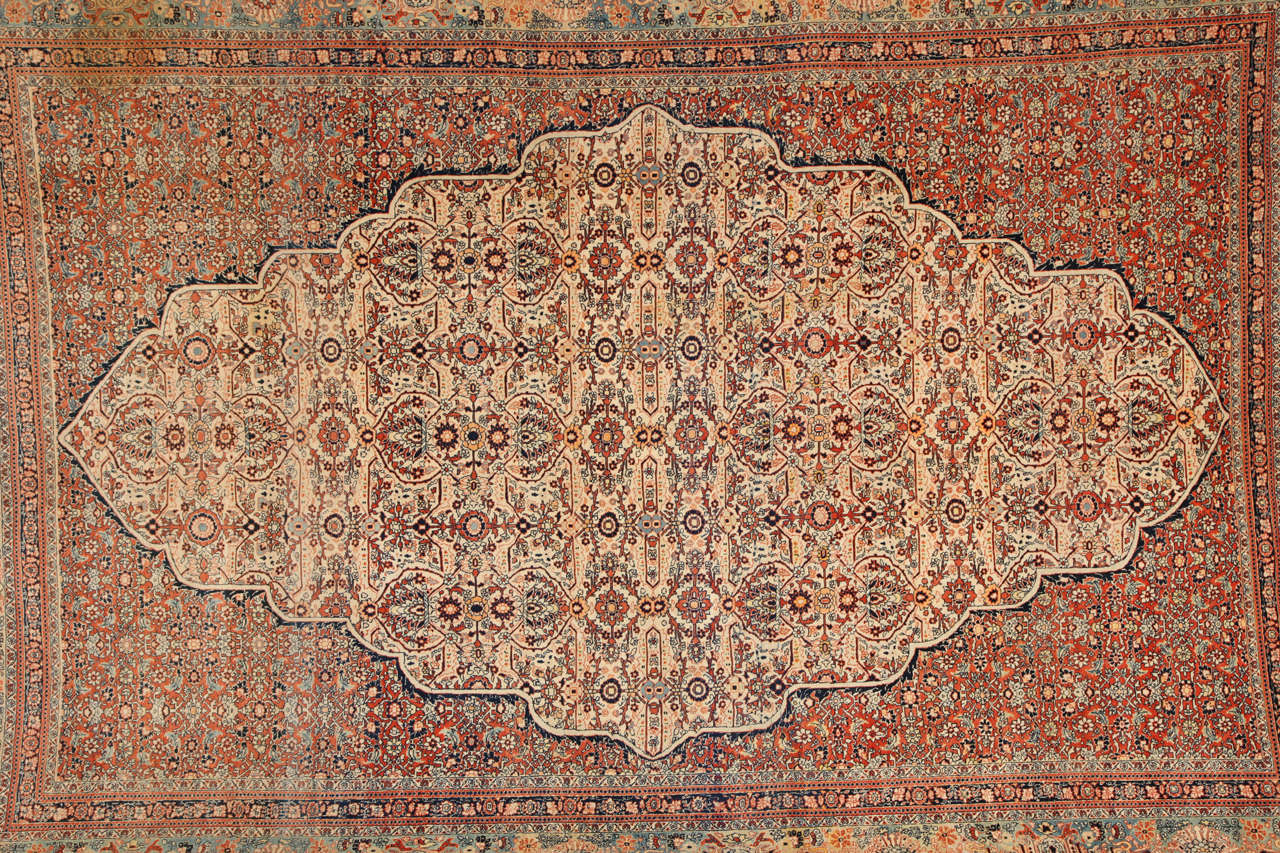 This Persian Haji Jalili Tabriz carpet, circa 1890 consists of a cotton warp and thread, hand-knotted wool pile and natural vegetable dyes. It is an exquisite and highly intricate piece from the workshop of master weaver Haji Jalili, one of the