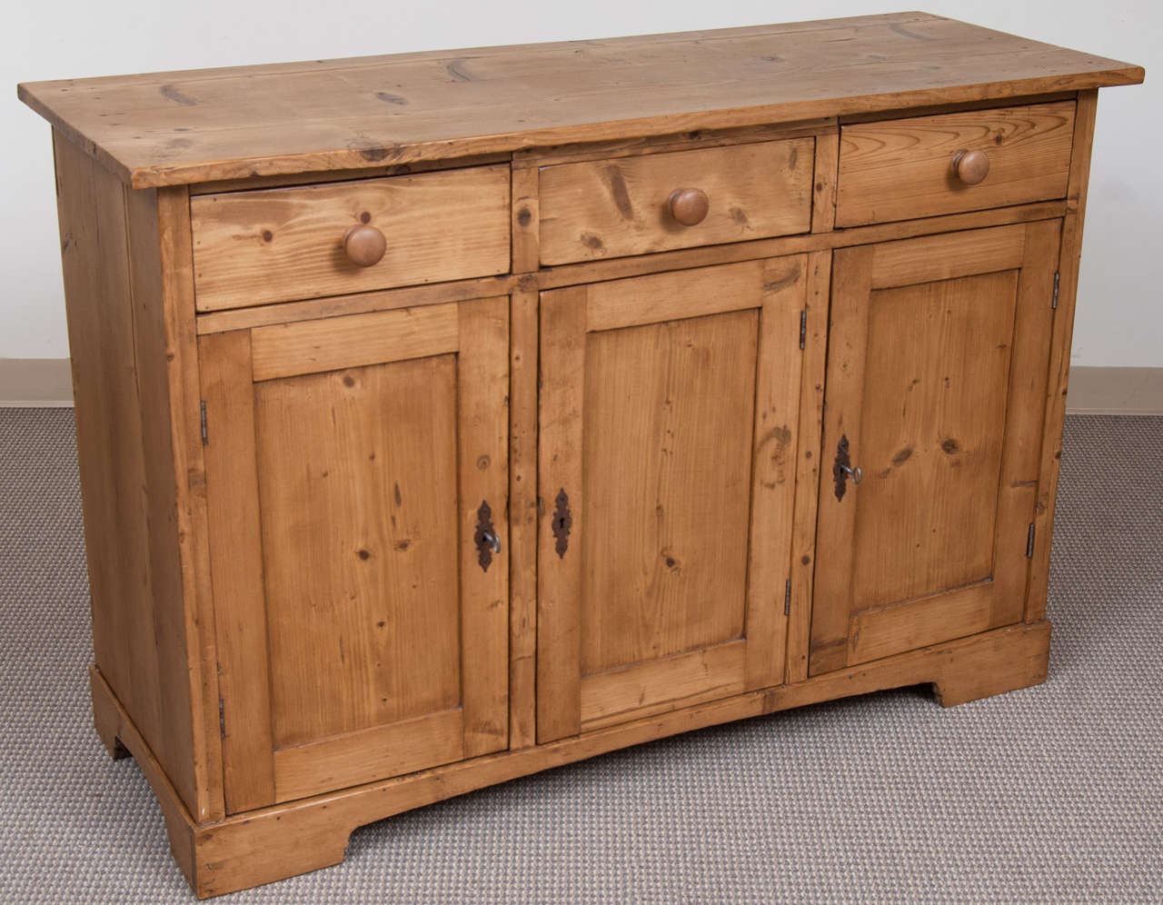 A plain and functional dresser base of generous size, featuring three hand-cut dovetailed drawers above three doors.  Great as a kitchen piece, a media centre or as storage in an office.