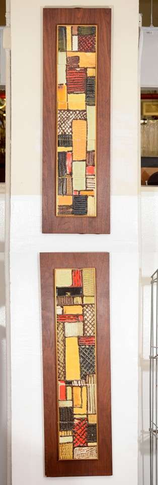 A pair of vintage wall mounted tiles by Harris Strong in warm tones with wood frames.