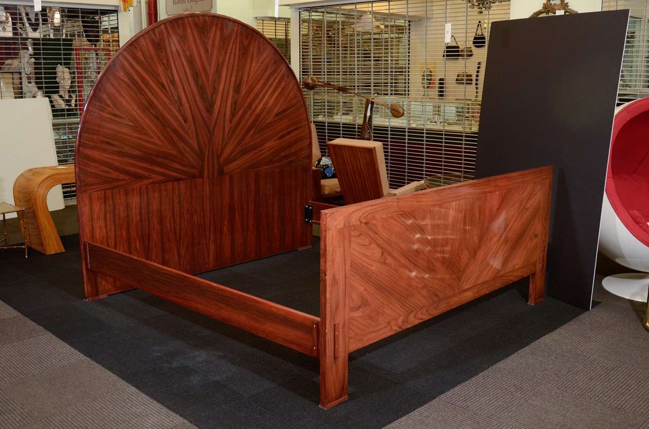 A large French vintage art deco king size bed frame in rosewood veneer.
