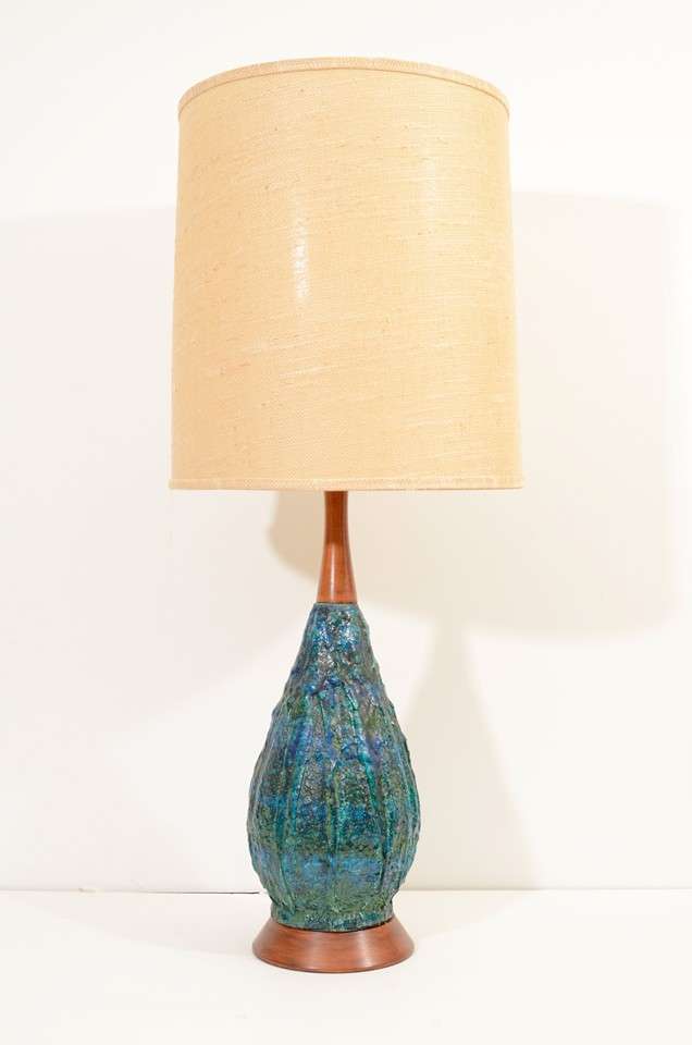 A pair of vintage table lamps with speckled blue lava glaze bodies, wood detailing and original burlap shades. They are in overall good vintage condition with age appropriate wear; some spotting and snags to shades commensurate with age and