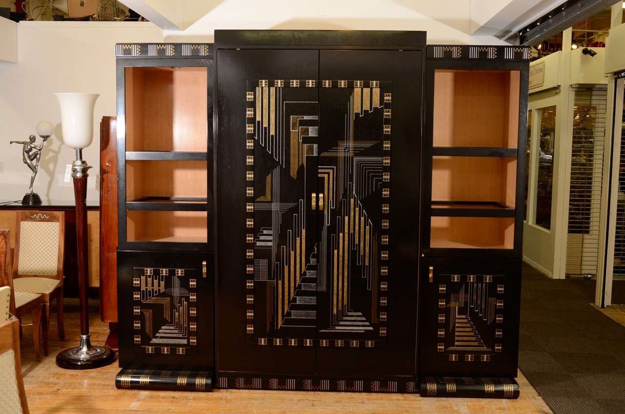 A custom Art Deco style entertainment center in ebonized wood with hand-painted geometric detailing. The two side cabinets are lighted from the top.

Reduced from $14,000.00.