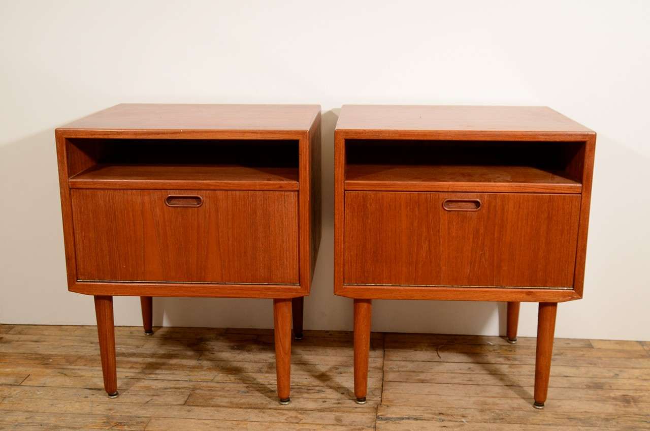 A pair of vintage night stands or side tables with a narrow storage space above a lower cabinet.