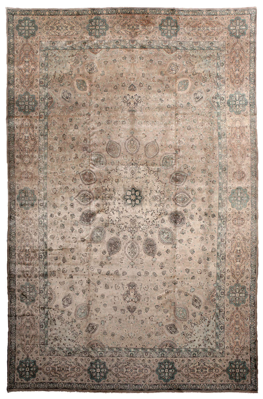 A softly subdued Antique Tabriz Persian Rug. Amber, pale mauve, sage, pale orange, and dark red predominate. A palette of harvest or desert colors would do nicely.