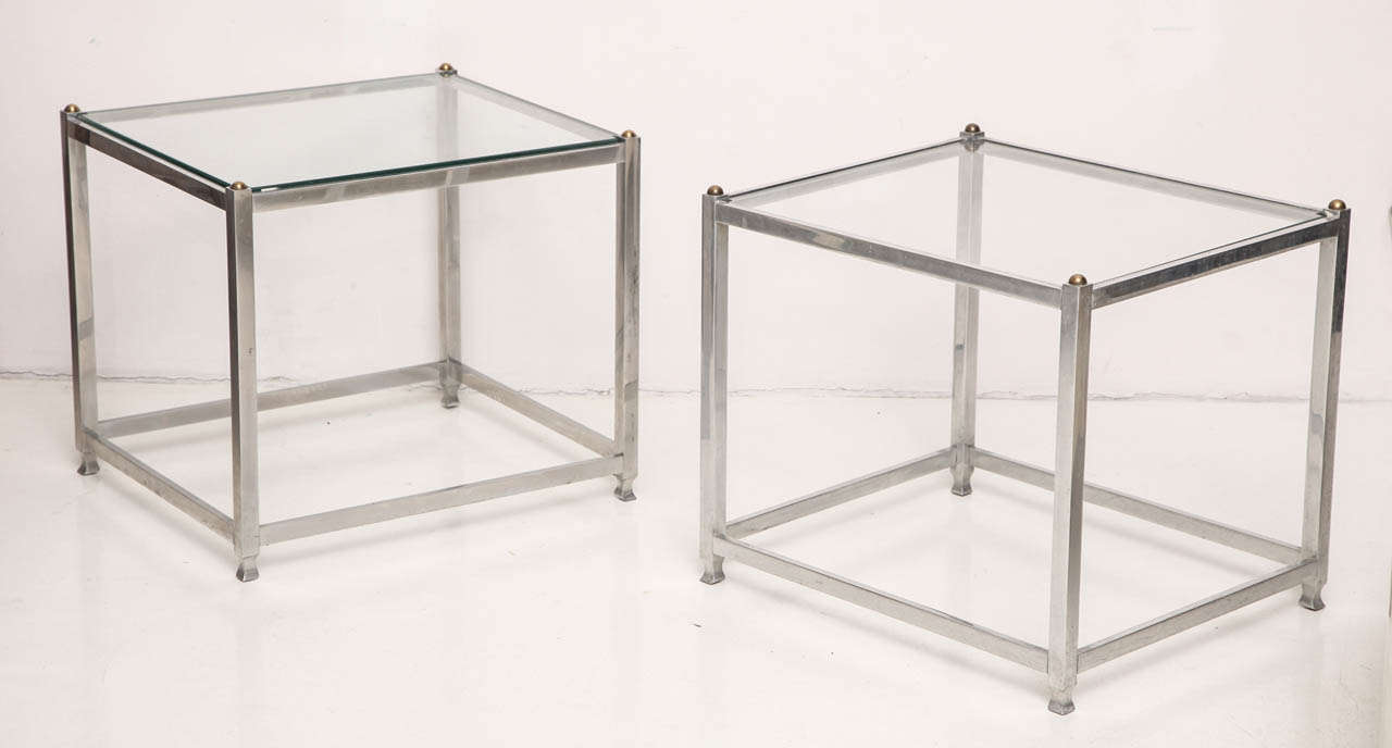 JOHN VESEY (1925-1992)
Near pair of side tables in aluminum and brass with glass top.
American, ca. 1970