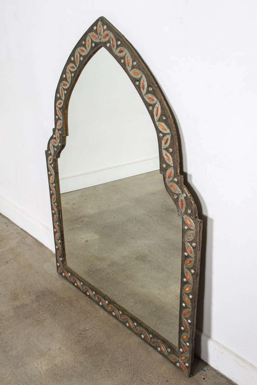 Moroccan mirror inlaid with camel bone and brass metal filigree intricately carved with classic elements of Moorish design such as geometric form using symmetry and inlaid decoration. This style is based on the architecture and design principles of