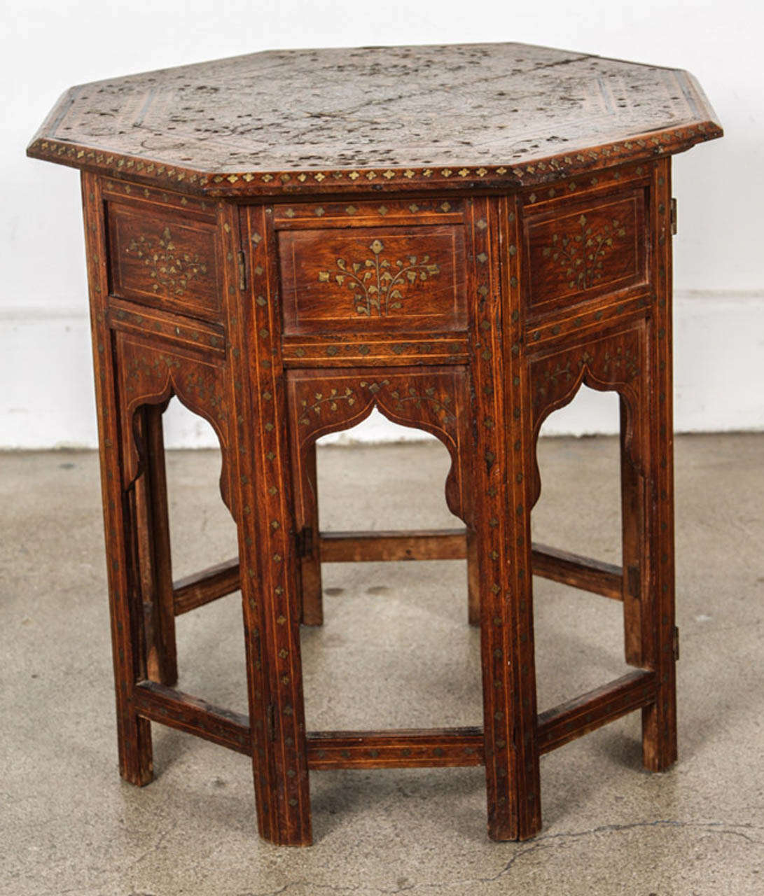 Late 19th century Anglo Indian folding brass inlaid octagonal side table.
Fine and elegant Anglo-Indian octagonal rosewood table with elaborate brass and ebony inlay.The octagonal surface is finely carved and inlaid with brass and ebony designs (