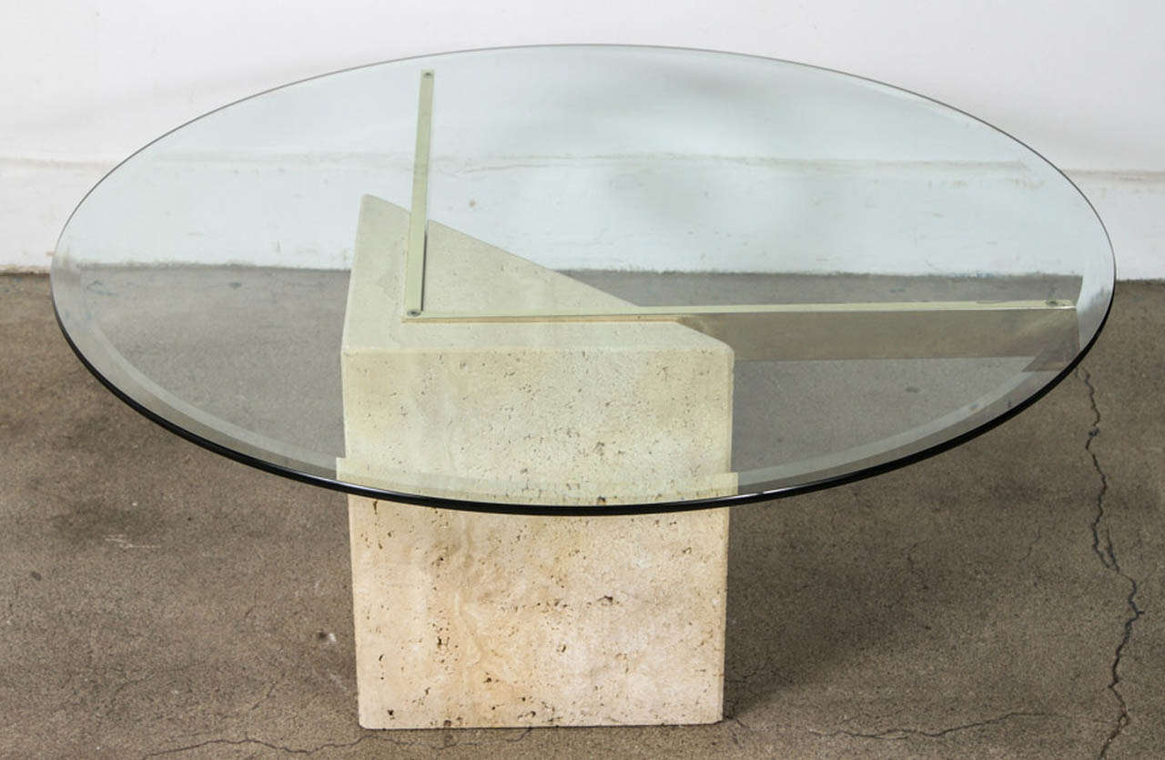 1970's elegant coffee table made of a diamond shape travertine with beautifully color striation.
The glass is sitting on 2  brass arms forming a V.