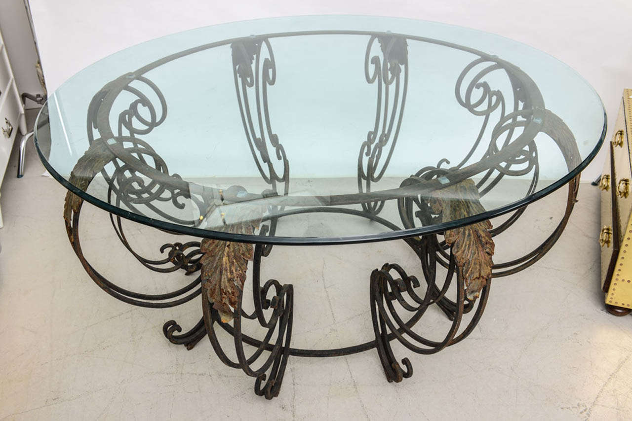 French wrought iron center table with scrolling legs and applied leaves.  The base has the perfect patina with hints of verdigris consistent with its age.
