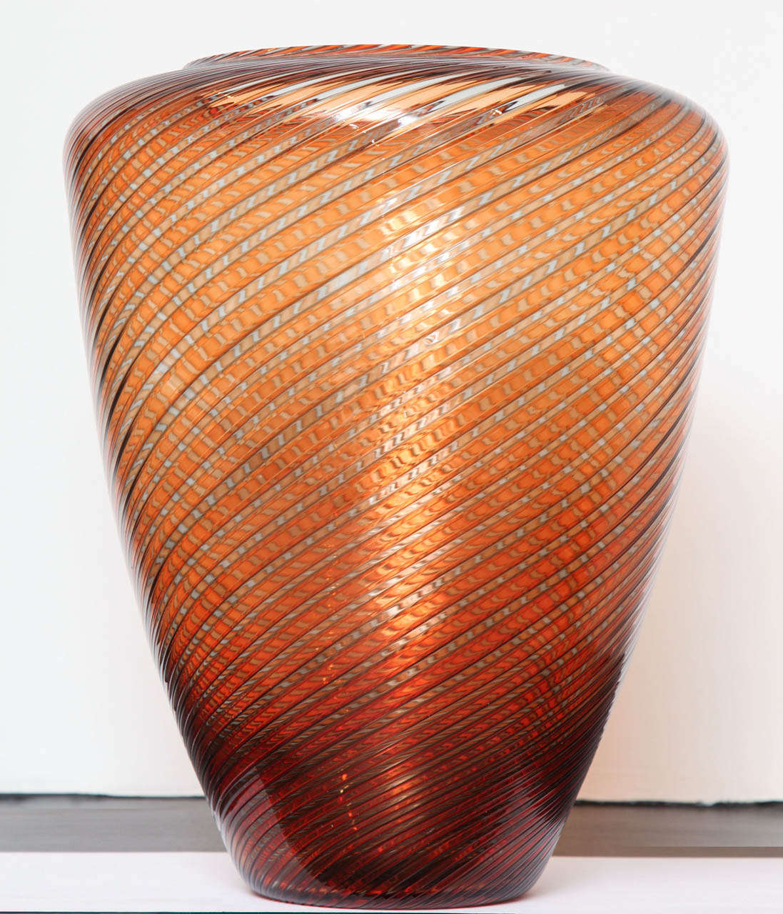 Signed Cenedese Murano Glass Vase. Pink-orange coloration in a swirl pattern.