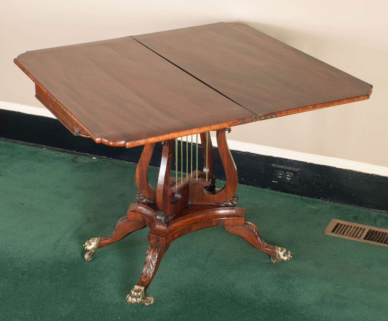 This exceptional Philadelphia games table was the product of a master cabinetmaker - the burled elm inlay is highly unusual - when opened, the top spins to initially reveal an inner compartment and folds out to lie flat in card-table dimensions (see