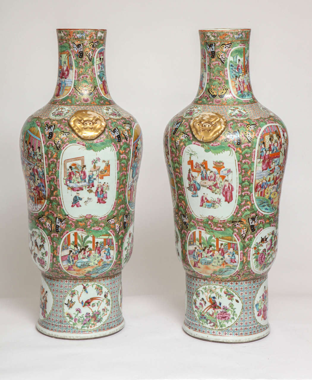 An unusual pair of large Chinese export canton famille rose thousand butterfly porcelain vases. The vase has a very unusual shape and was most probably made by specific order. The entirety of the vase is painted with a 24-karat gold background, then