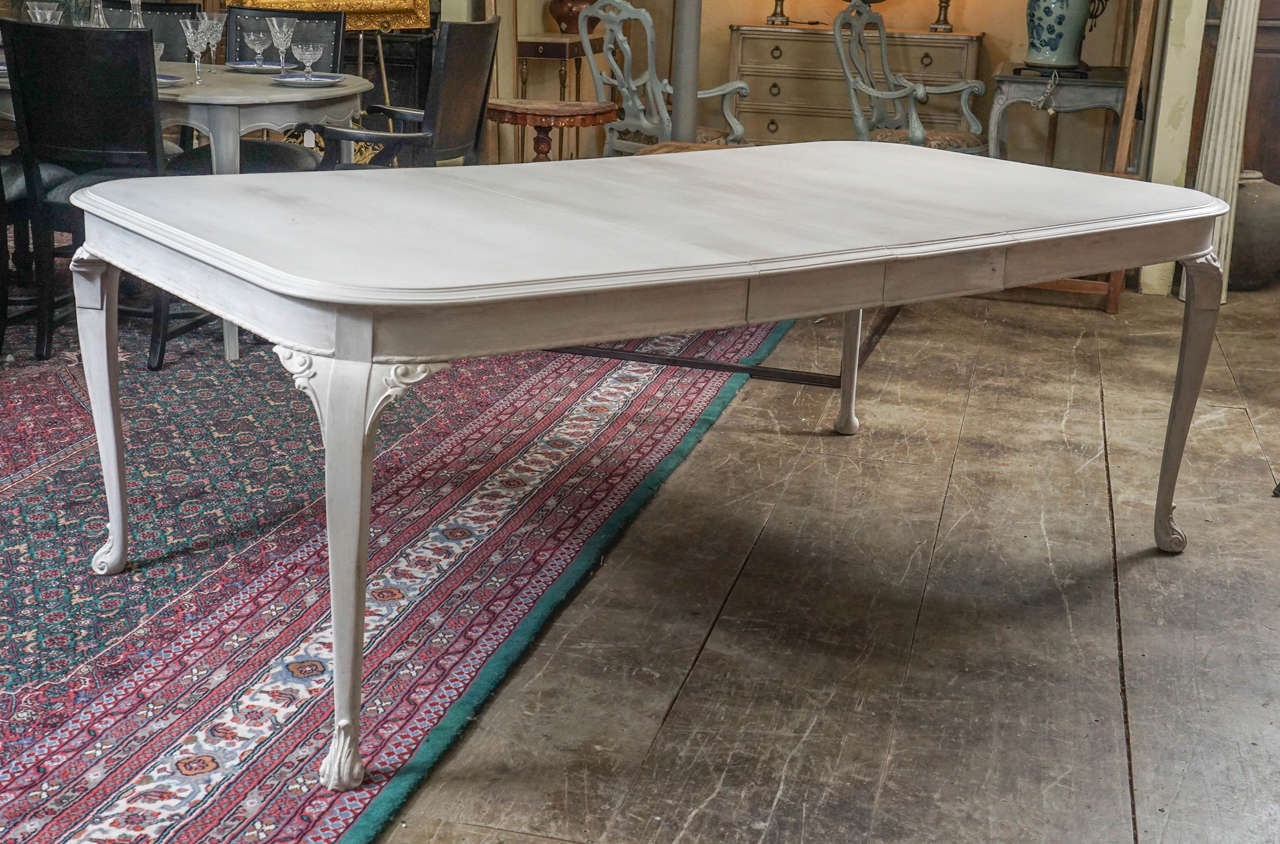 Well-made Swedish style dining table sits on bracketed cabriole legs and, with two leaves, can seat up to eight people. Leaves sit on sliders and are secured in place with pegs and holes. Table can be locked without leaves. Third leaf available but