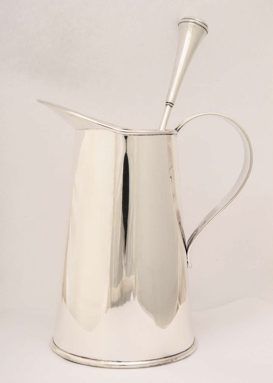 A wonderful sterling silver cocktail mixing jug, in the form of a milk jug.

The piece comes with the original, matching Cartier sterling silver cocktail mixing spoon.