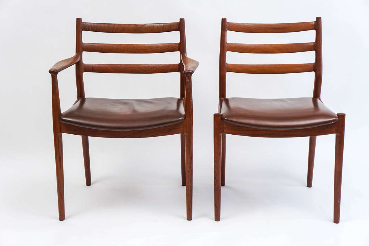 Eight teak France & Son leather dining chairs, Niels Moller design. The set includes six side chairs and two armchairs, all with apparently original leather seats. The leather shows some signs of wear, consistent with age and use, that frankly, adds