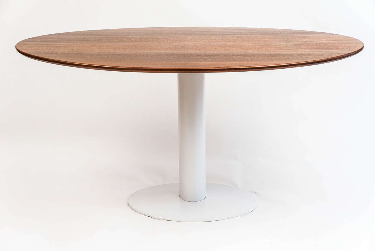 Mid-Century steel base has been sandblasted and restored to its original beauty. Mahogany elliptical top was added later, transforming this into an elegant table in a useful 55
