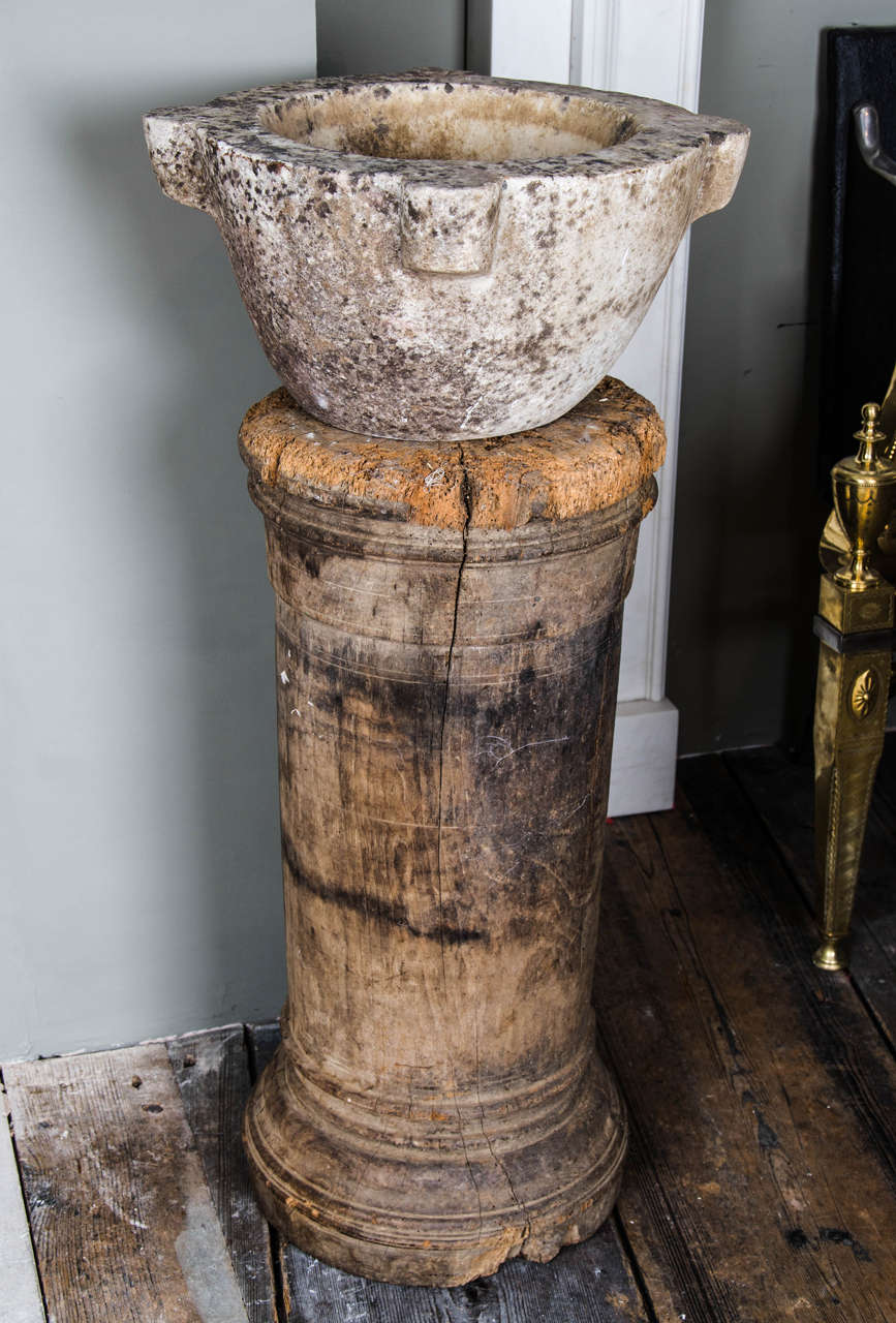 An 18th century mortar on contemporary softwood socle.