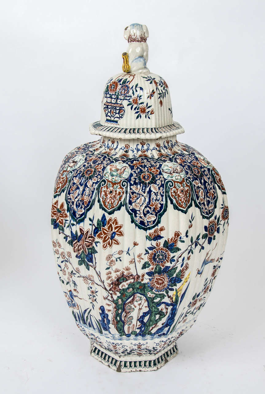 A massive garniture of 19th century Delf vases. 1