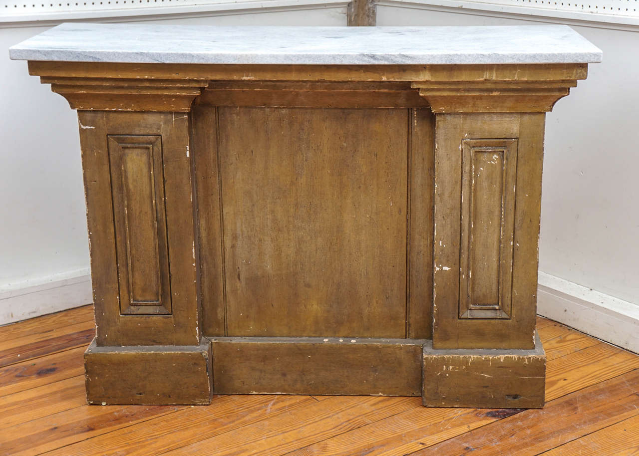 This very early lectern dates between 1850-1870 and came from a church in Susquehanna County PA. The front has a stylized panel in the center, flanked by two tall paneled columns. The end of the columns also have tall panels. The paint is original.