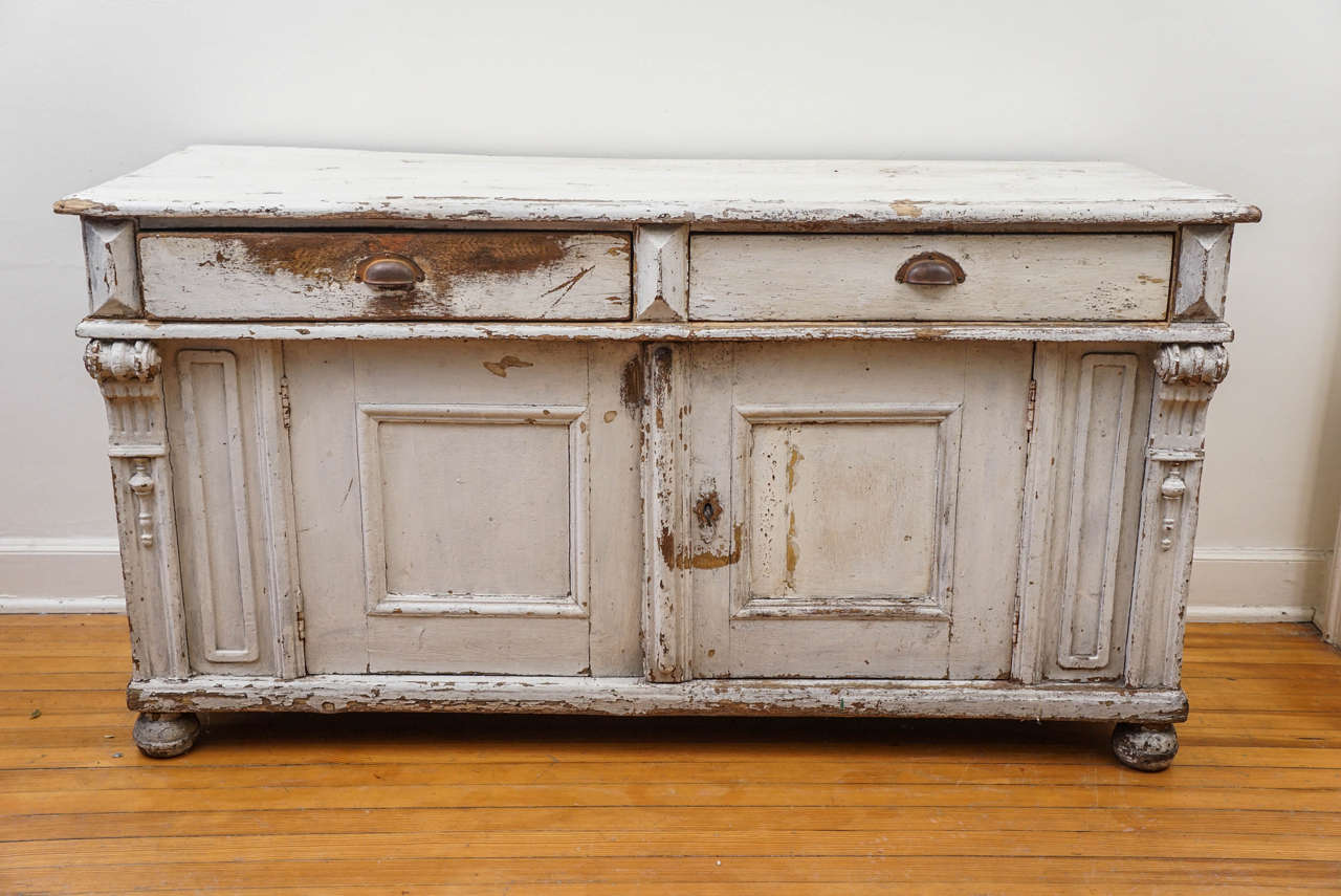 There is no more stunning buffet or sideboard in our store. With original off-white paint and wonderful romantic lines throughout this piece, it will take your breath away. If that weren't enough the hardware and lock and key are original as well as
