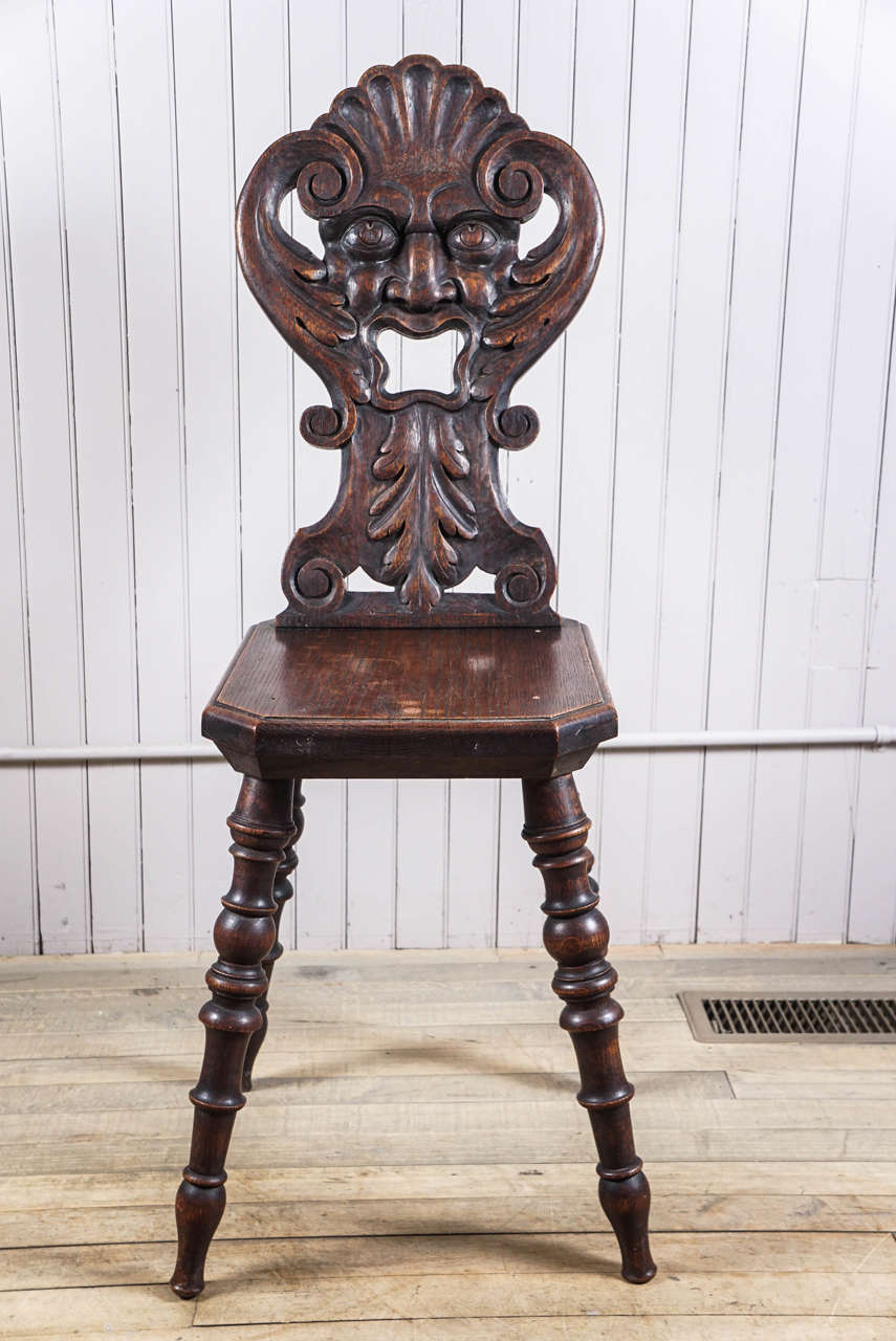 19th century Black Forest carved fantasy chair. North wind with open mouth, oak and original patina surface.