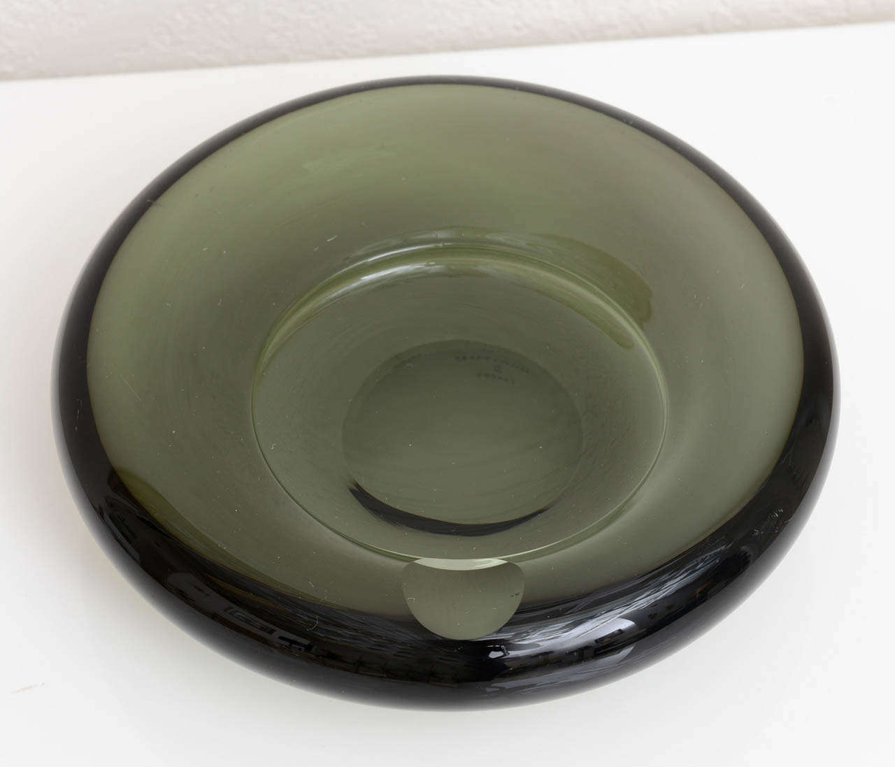 Stunning Mid Century glass ashtray by Per Lutken for Holmegaard.  Signed on underside. Reduced from $375.00.

Please feel free to contact us directly for a shipping quote or any additional information by clicking 