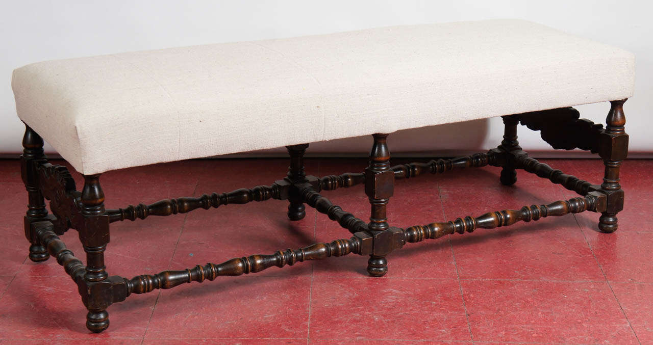 Upholstered bench with turned legs and carved panels at either end.  Perfect in a hall or in front of a fireplace, possibly extra seating at the dinner table or at the foot of a bed.

Louis XIV Style bench, barley twist, turned leg, Charles III.