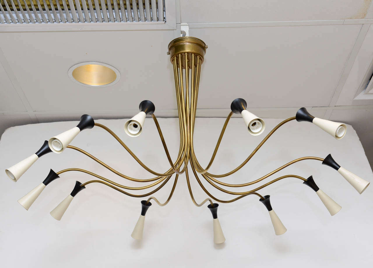 Elegant flush mount brass 12 arm chandelier in the Stilnovo Style . Made in Italy, circa 1960's.