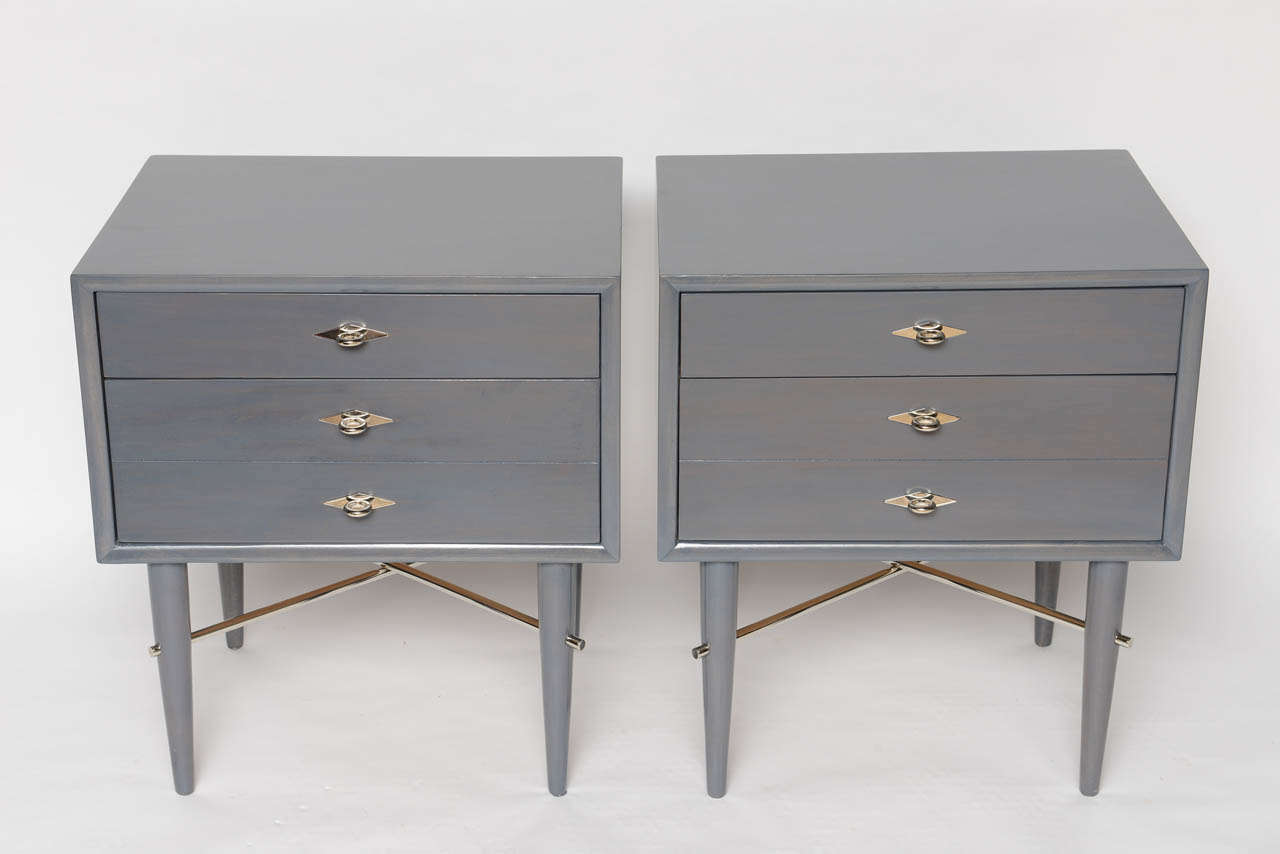 A fantastic pair of sidetables/ nightstands with nickeled cross bars and pulls.  Two drawers (one single, one double).