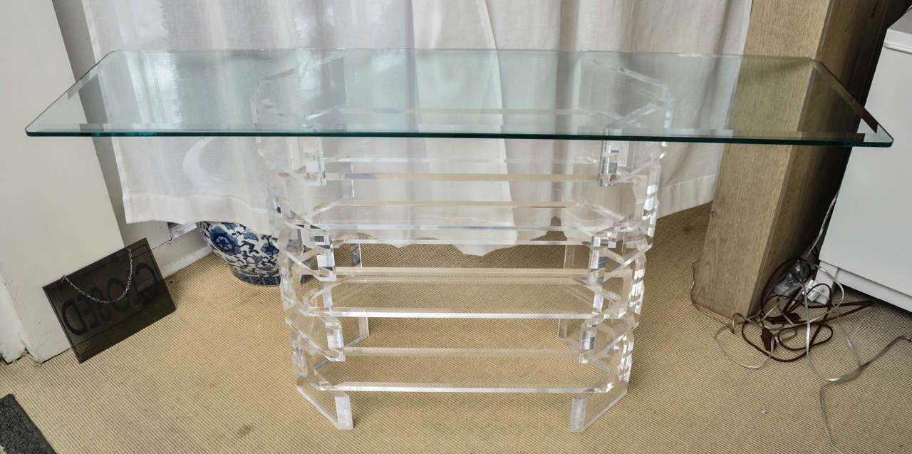 Mid-Century console with oval Lucite base and rectangular beveled glass top.