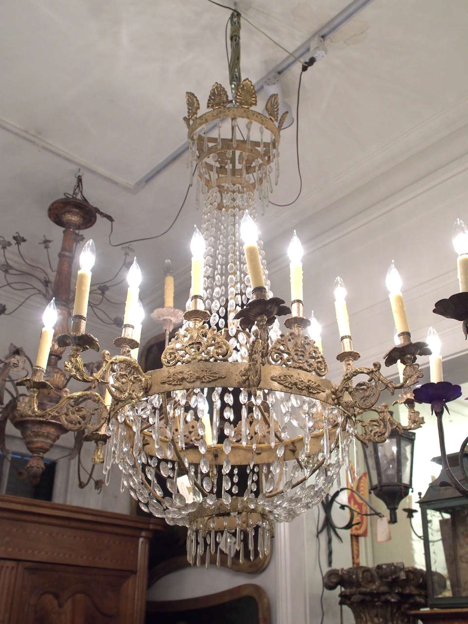 Italian Gilt Iron and Crystal Empire style Chandelier with 16 lights. Gilt Iron frame and crystal dressing. This fixture has been re wired for US current rated 60 watts per light. It has natural beeswax sleeves and comes with a canopy and chain.