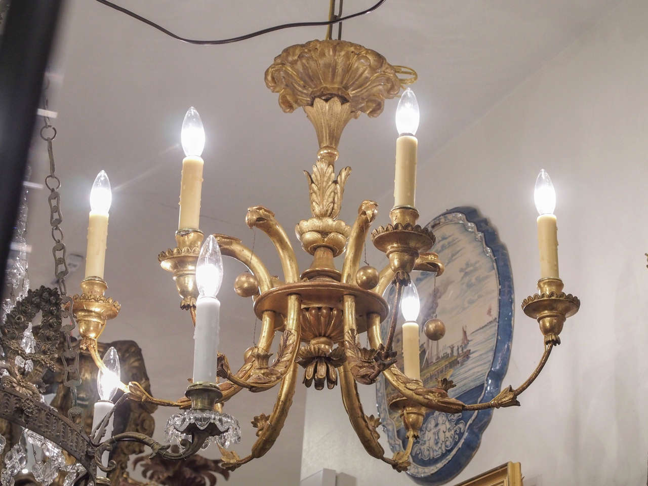 19th century German giltwood chandelier with six lights. Wood carving on iron armature. Unusual eagle head motif holding balls on chains. This fixture has been re wired to US current. Each arm is rated 60 W. It comes with chain and canopy and ready