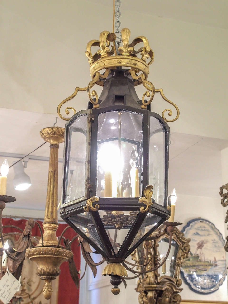 Italian pained iron lantern with gilt accents. Having six panels of glass and all surmounted with a gilt iron crown.