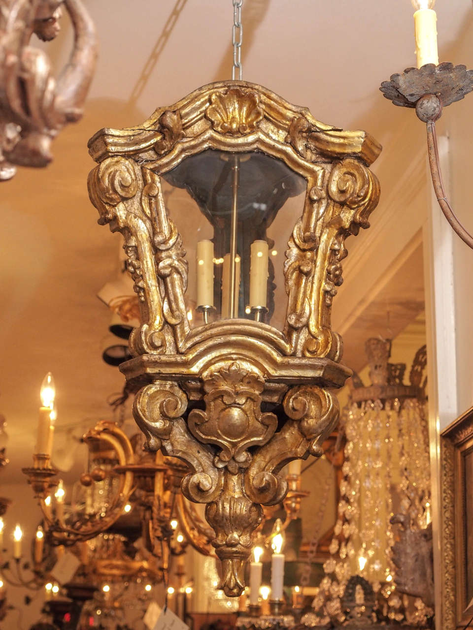 Italian Baroque giltwood lantern with three sides. One-door and glass panels. These have been wired with a trifed candle stem and come with a canopy and chain ready to hang. We recommend to have an electrician check them as wired can come loose in