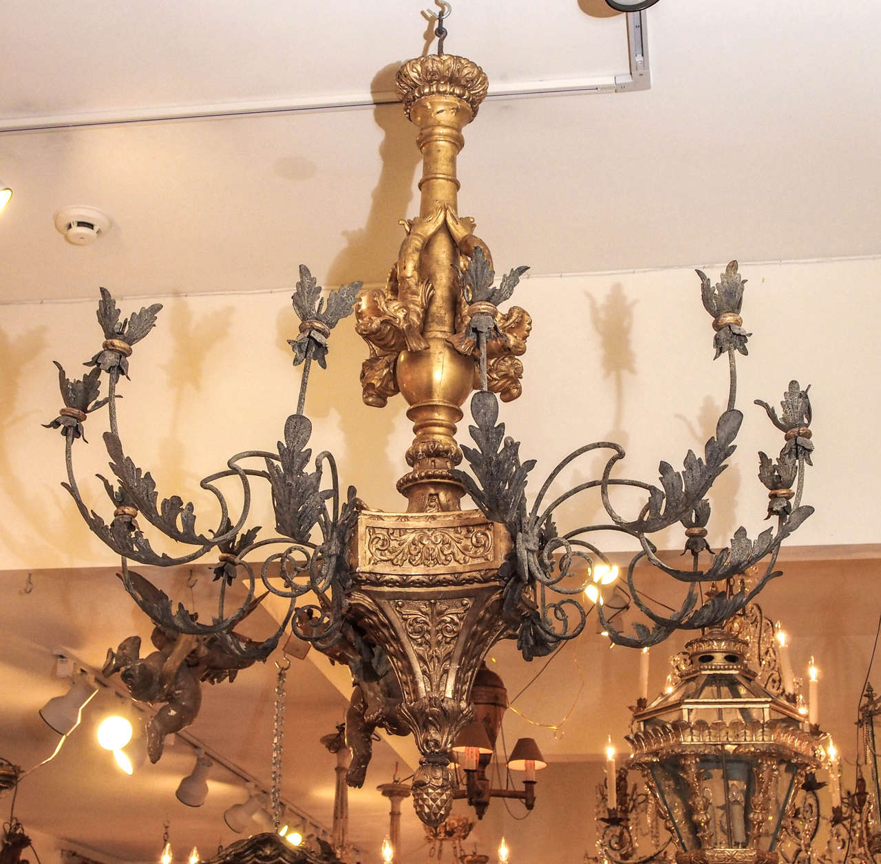 Monumental giltwood and iron chandelier with dolphin and foliate decoration. 
19th century.