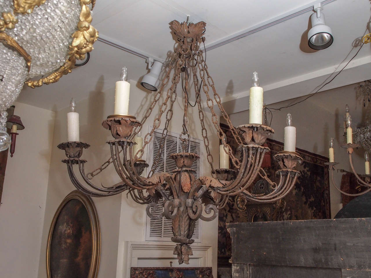 Handmade Italian iron six-arm chandelier with interesting chains and acanthus decoration.