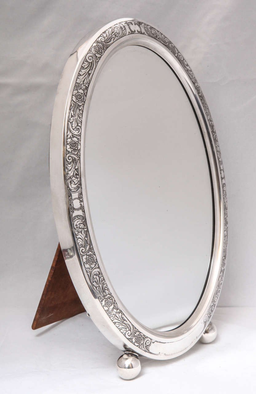 Large, footed, Art Nouveau, sterling silver, etched, oval table mirror on ball feet, William B. Kerr & Co., New Jersey, circa 1895. Wood back. @14 1/2