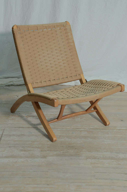 Woven rope folding chair in the style of Hans Wegner.