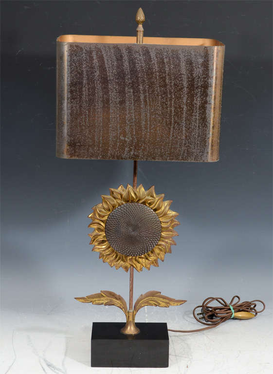 A vintage lamp by Charles et Cie in the form of a bronze and gilt-bronze sunflower with metal shade.