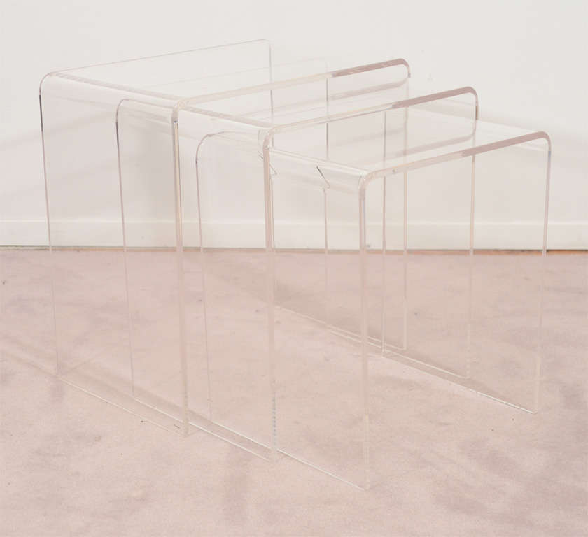 A set of three lucite waterfall form tables that can be extended, collapsed or separated to meet any table needs.

Reduced From: $1150

Dimensions:
Large - 18H x 17L x 11.5D
Medium - 16.5H x 15L x 11.5D
Small - 15H x 13.5L x 11.5D