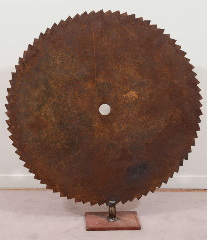A pair of sculptures consisting of rust patinated steel circular saw blades mounted on a base.

Reduced from:  $750