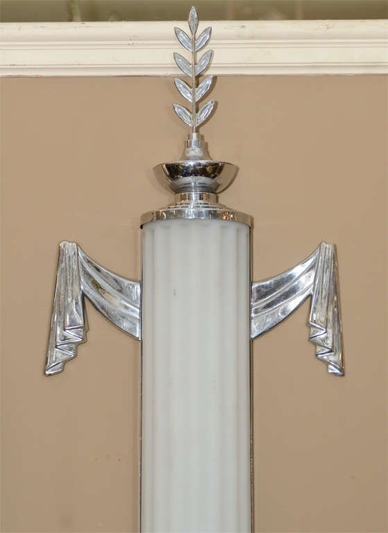 A pair of art deco cylinder form sconces with fluted frosted-glass shades and chrome detailing. The pieces are by Lurelle Guild for Chase.