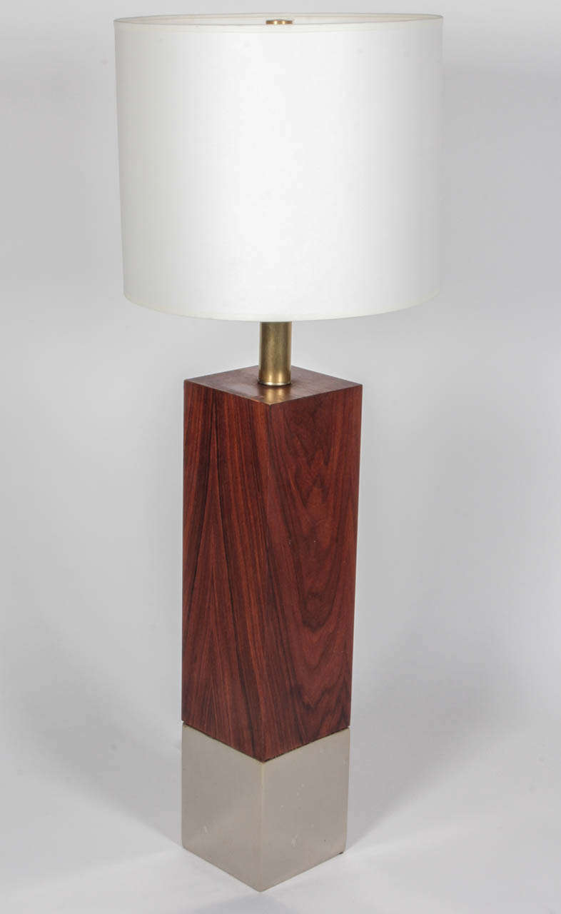 Walnut table lamp with wide chrome base by Laurel.  USA, circa 1960.  Newly rewired with French black silk twist cord and new socket; shown with white paper drum shade.  

Dimensions: 
34 inch total height
20.25 inch height (wood base only)
25